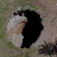 "Oops, Did You Feel That? Sinkhole Makes Surprise Appearance on Garden Street!"